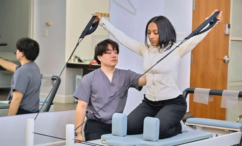 One-to-one Pilates instruction with exercise straps