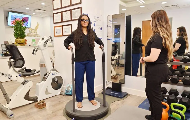 A person standing on a body-analysis platform